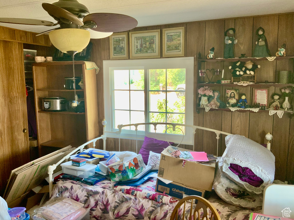 Bedroom featuring wooden walls