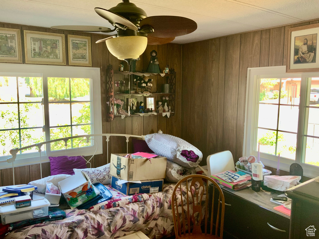 Living room with wooden walls and ceiling fan