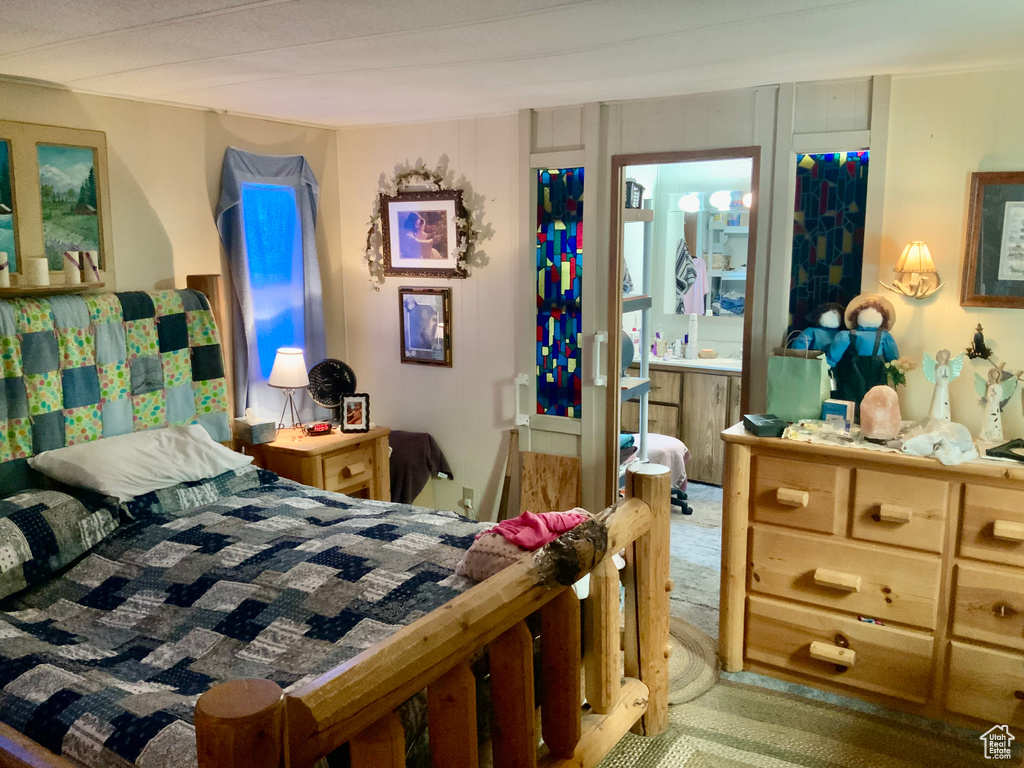 Carpeted bedroom with connected bathroom
