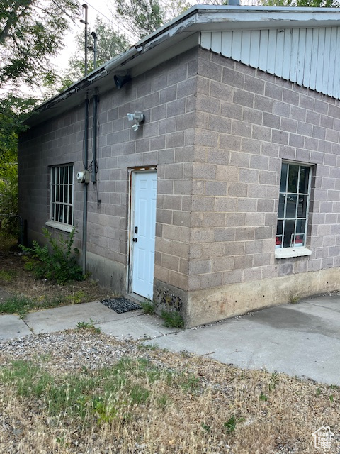 Entrance to property with concrete block siding