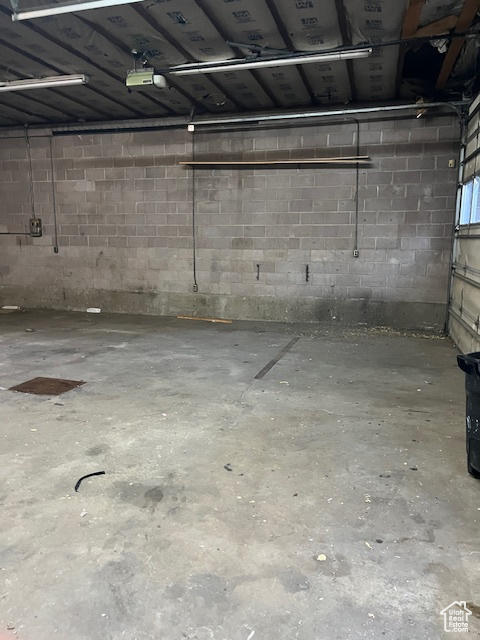 Garage featuring concrete block wall