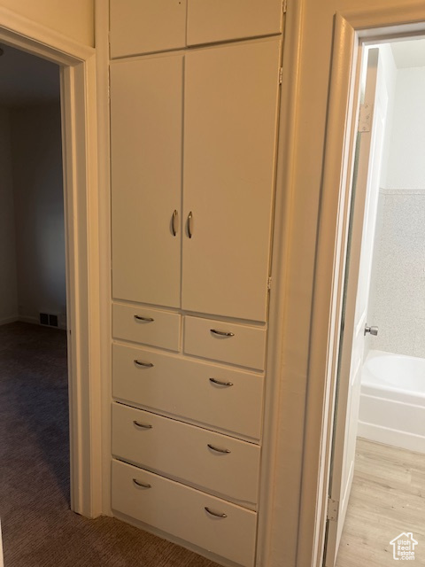 Detailed view of a tub to relax in and wood finished floors