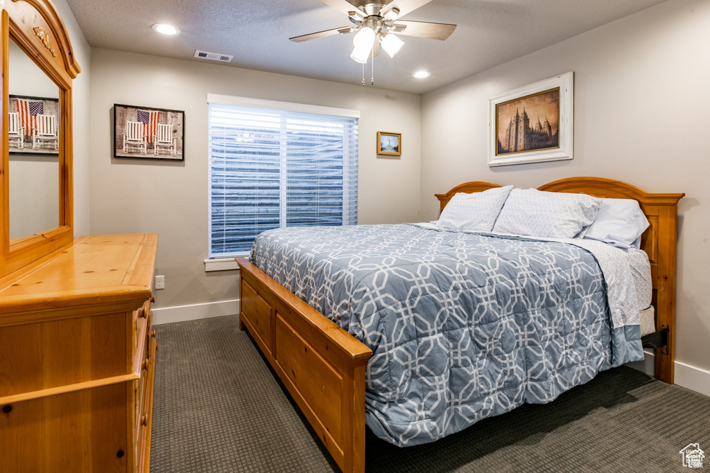 Bedroom featuring dark carpet, recessed lighting, and a ceiling fan