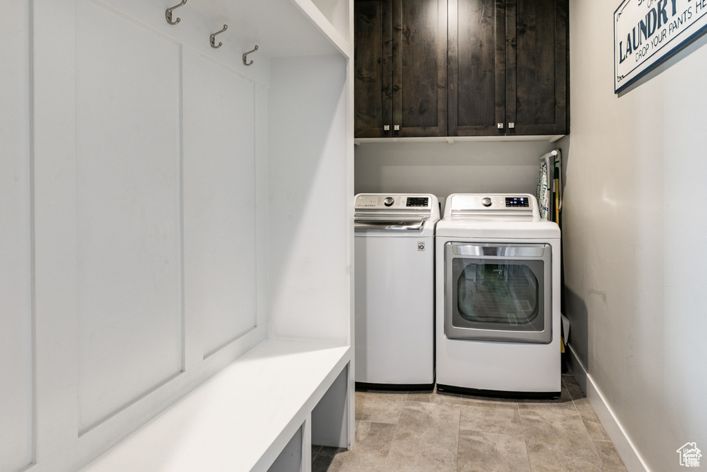 Washroom with washing machine and clothes dryer and cabinet space