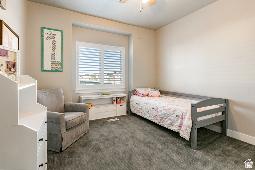 Bedroom featuring dark carpet and a ceiling fan