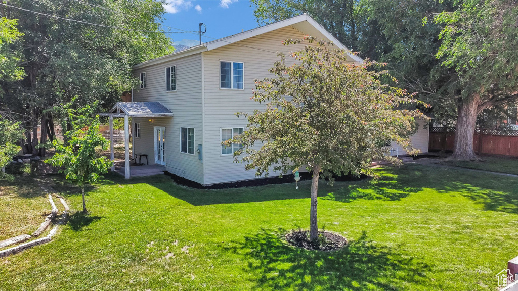 Back of property with a lawn