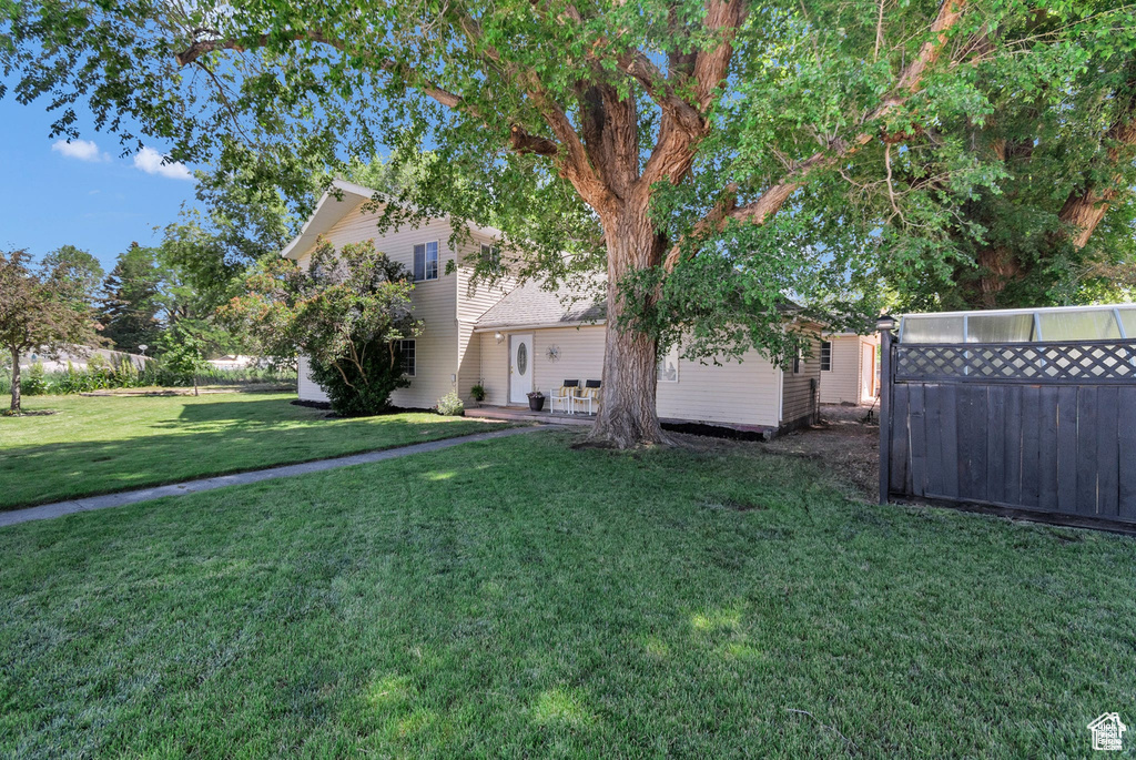 View of green lawn with a patio area