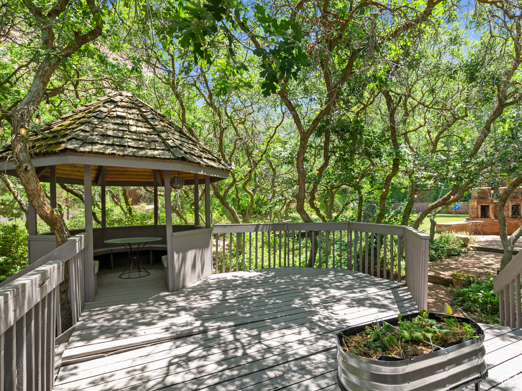 Wooden terrace featuring a gazebo