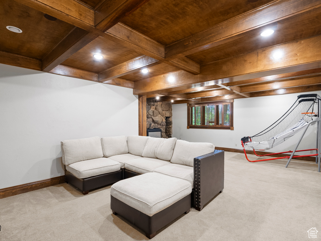 Living area with light carpet, recessed lighting, a wood ceiling with exposed beams, and a fireplace