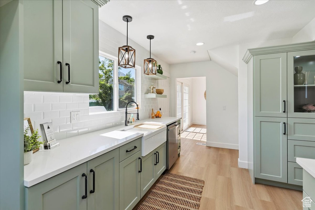 Kitchen with dishwasher, tasteful backsplash, green cabinetry, light wood-style flooring, and recessed lighting