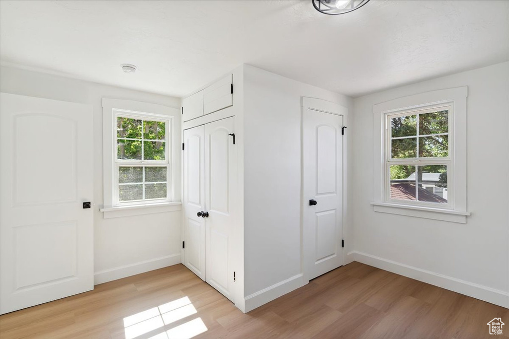 Unfurnished bedroom with light wood finished floors