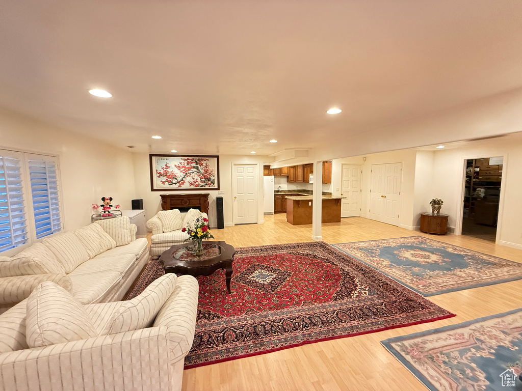 Living area featuring light wood finished floors and recessed lighting