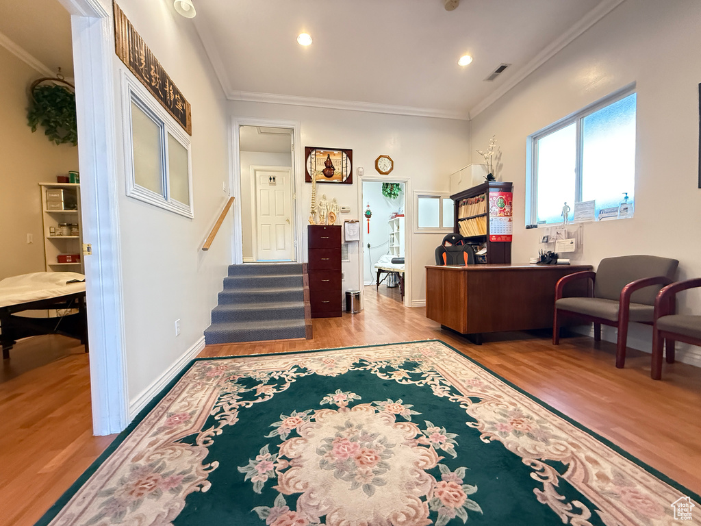 Office space featuring wood finished floors, ornamental molding, and recessed lighting