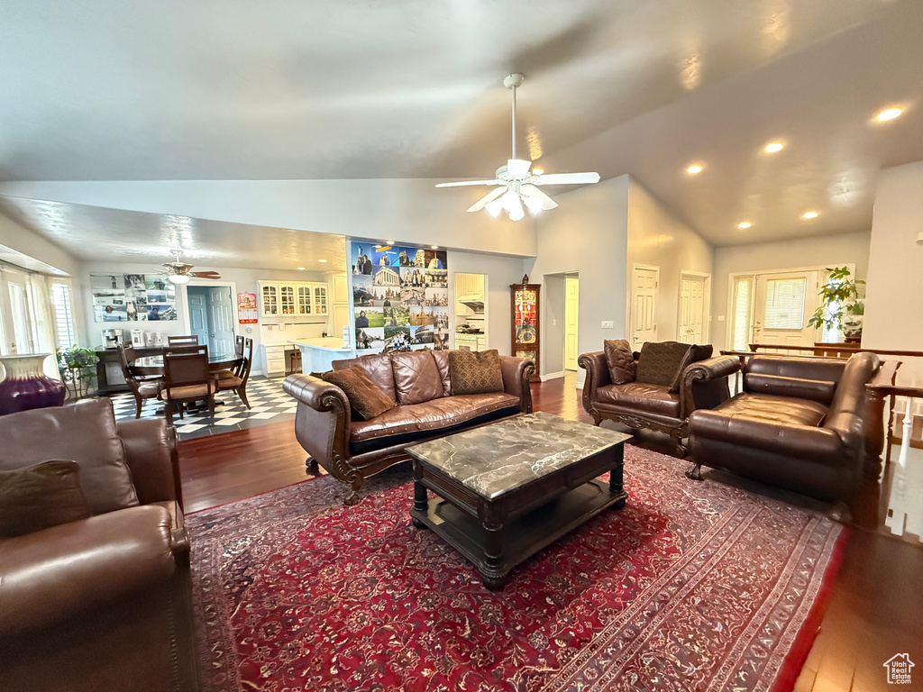 Living room with ceiling fan, hardwood / wood-style flooring, vaulted ceiling, and recessed lighting