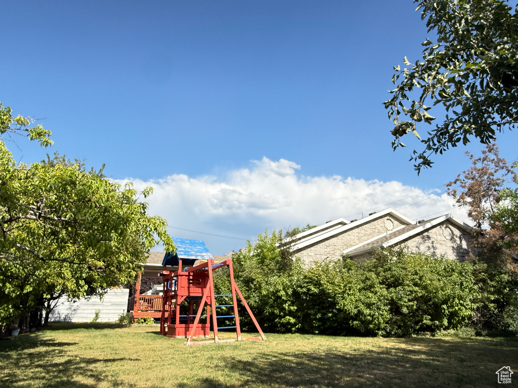 View of grassy yard with a playground