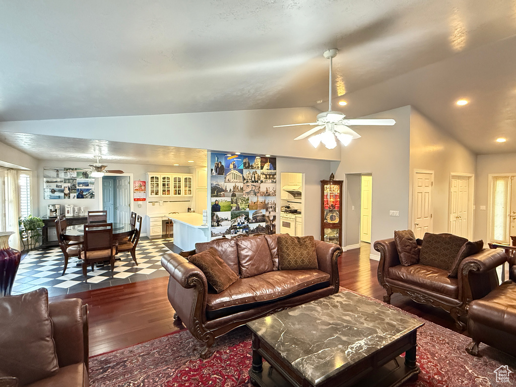 Living room featuring a ceiling fan, lofted ceiling, and hardwood / wood-style floors