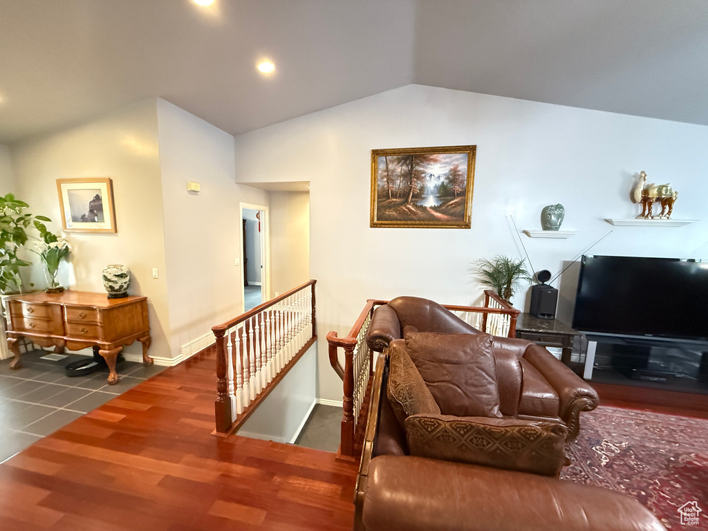 Living room featuring vaulted ceiling, wood finished floors, and recessed lighting