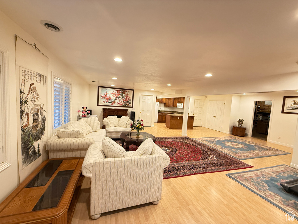 Living room with recessed lighting and light wood-style flooring