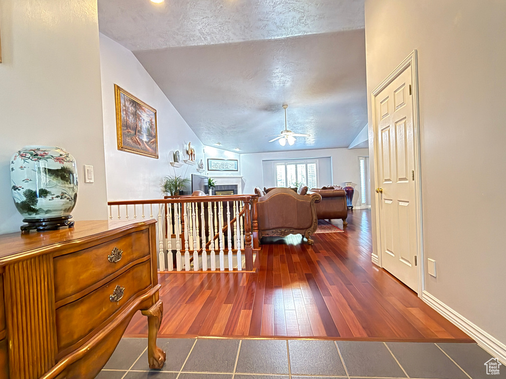 Hall with vaulted ceiling and dark wood-type flooring