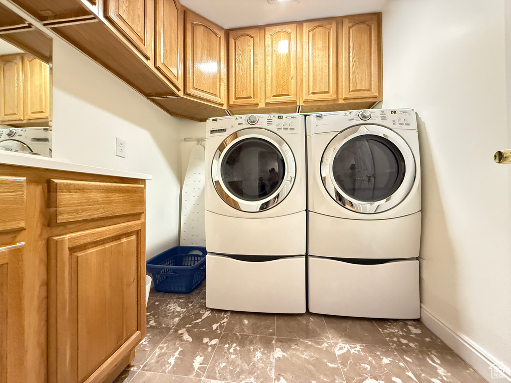 Laundry room with cabinet space and washing machine and clothes dryer