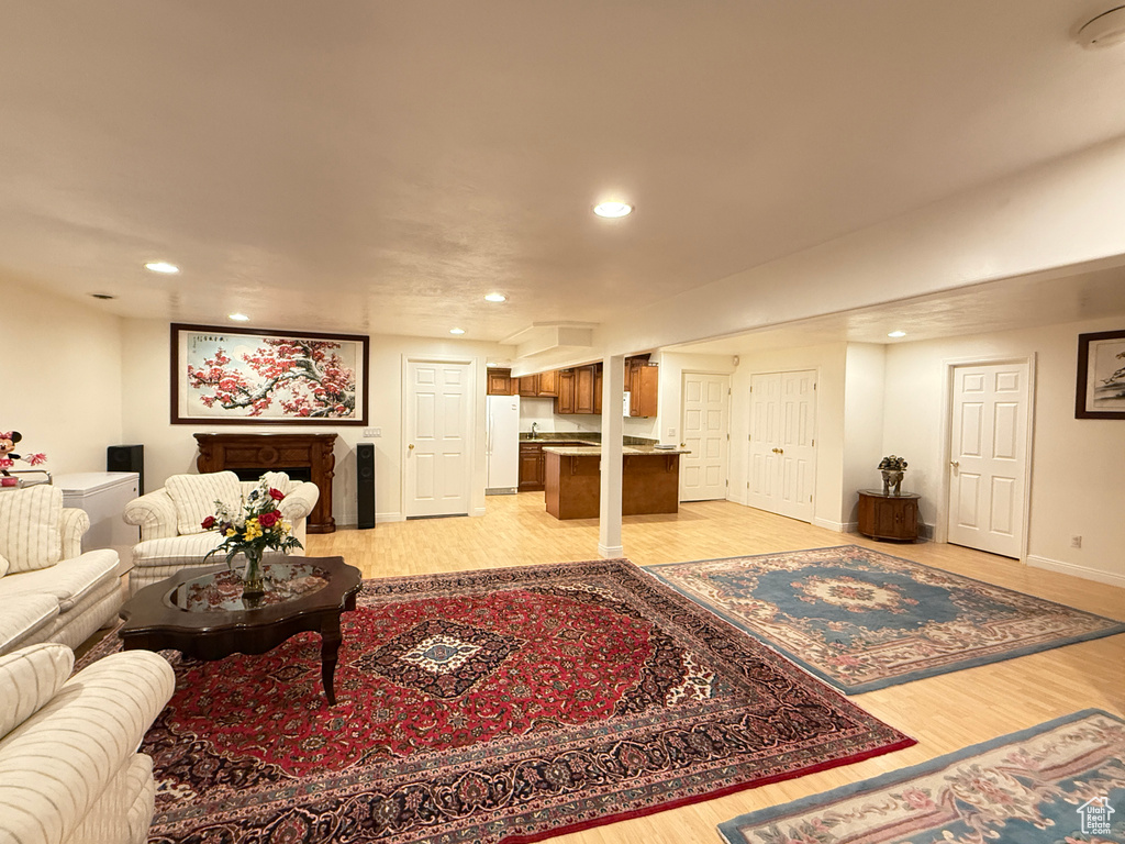 Living area with light wood-style floors and recessed lighting