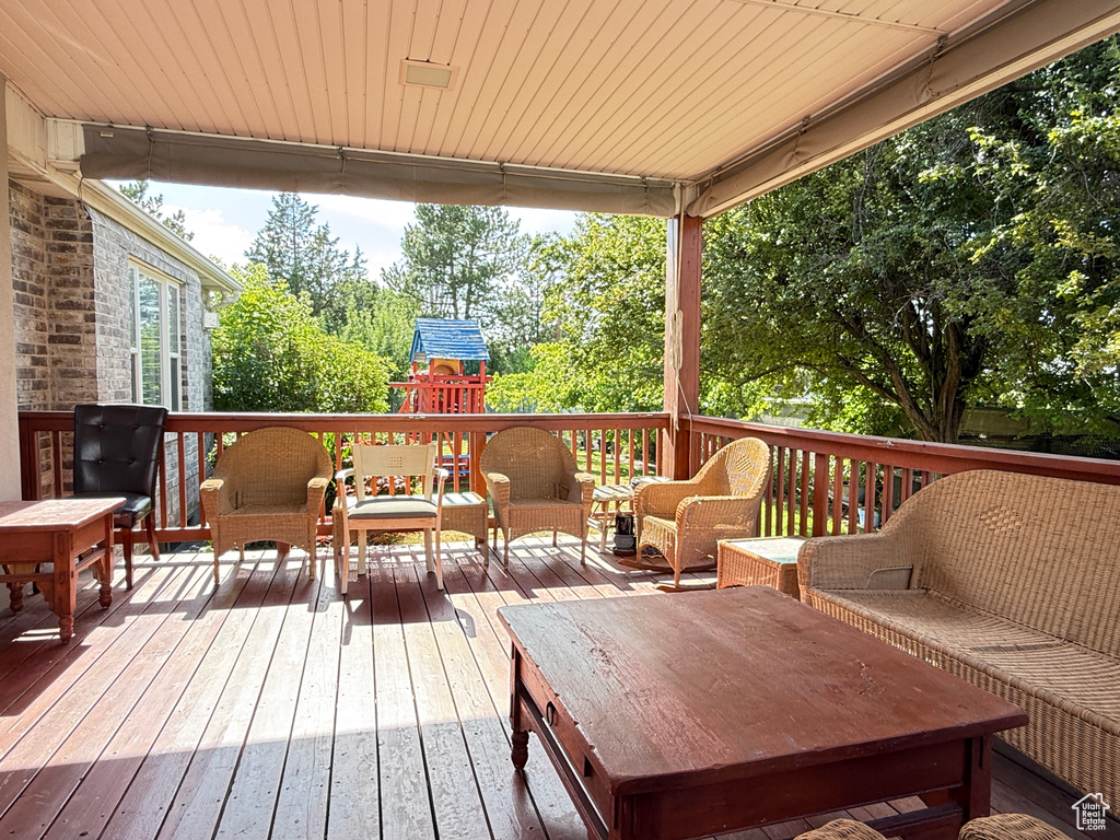 Deck featuring a playground and an outdoor living space