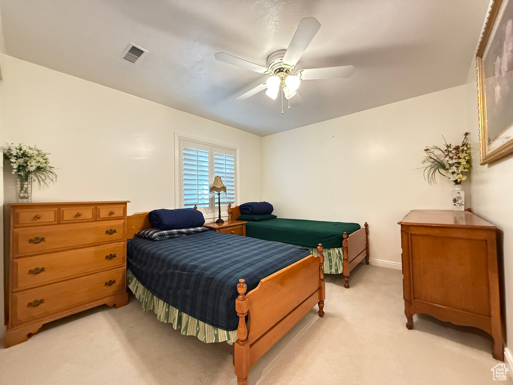 Bedroom featuring light carpet and a ceiling fan