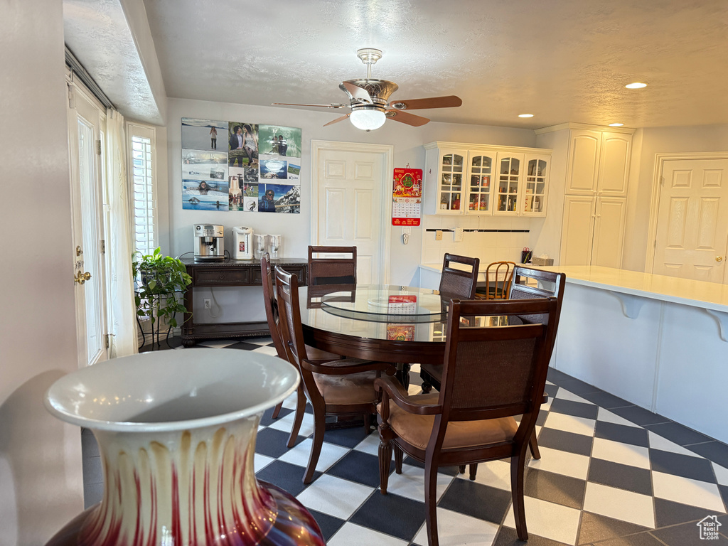 Dining space featuring tile patterned floors, a ceiling fan, and recessed lighting
