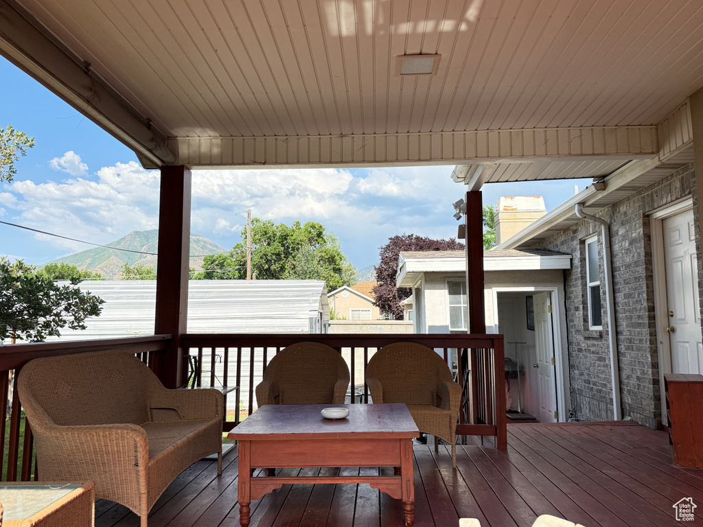 Wooden deck featuring a mountain view and outdoor lounge area