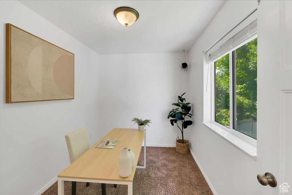 Carpeted office space featuring baseboards