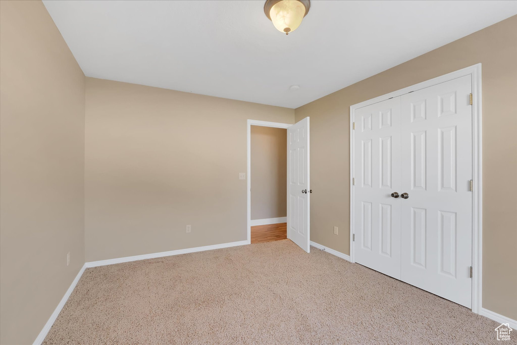 Unfurnished bedroom with carpet floors and a closet