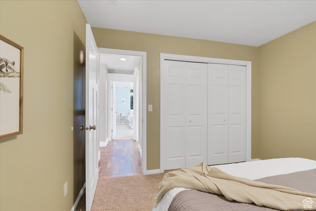 Bedroom featuring carpet and a closet