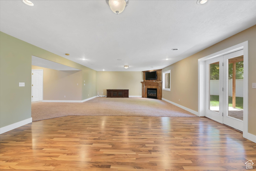 Unfurnished living room featuring recessed lighting, light wood-style flooring, and a fireplace