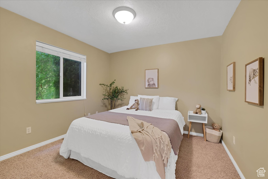 Carpeted bedroom featuring baseboards