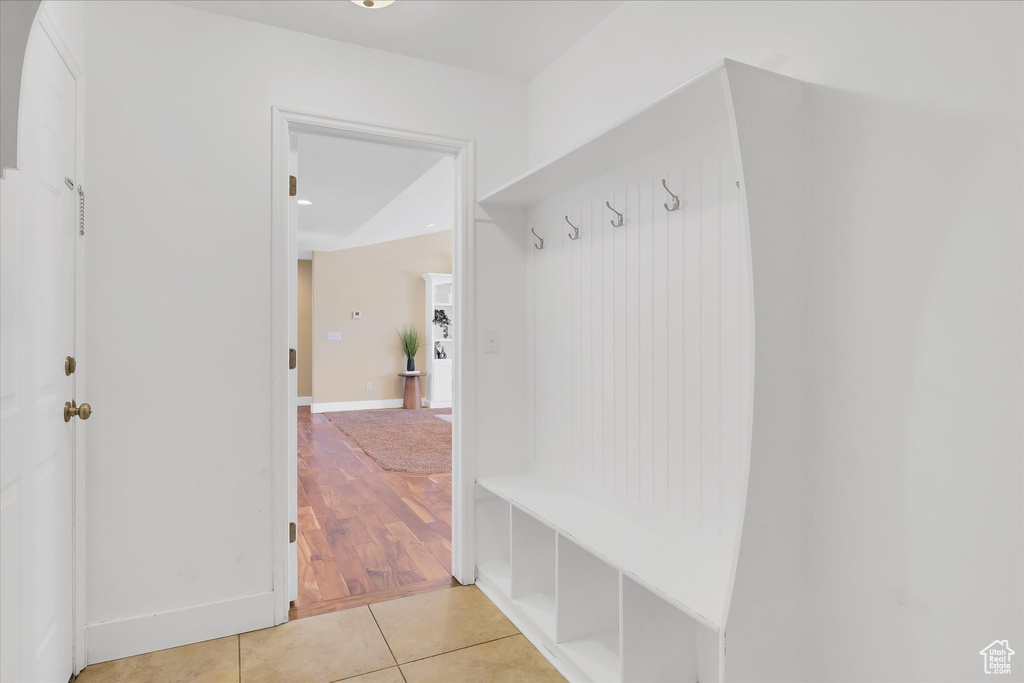 Mudroom with light tile patterned flooring and baseboards