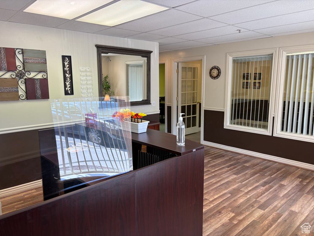 Interior space with wood finished floors and a paneled ceiling