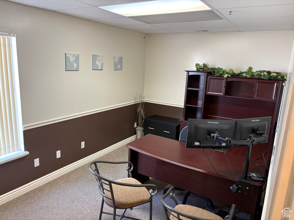 Home office with a drop ceiling and carpet