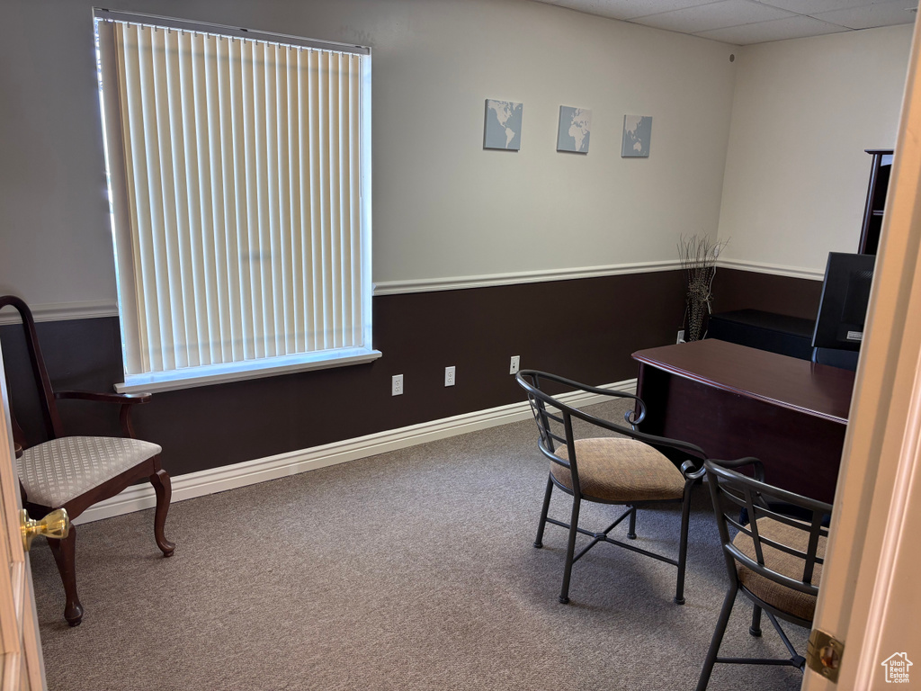 Home office with carpet floors and baseboards