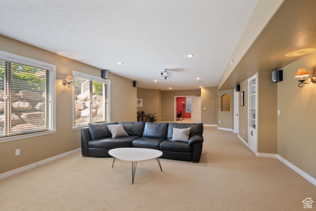 Living room featuring light colored carpet and recessed lighting