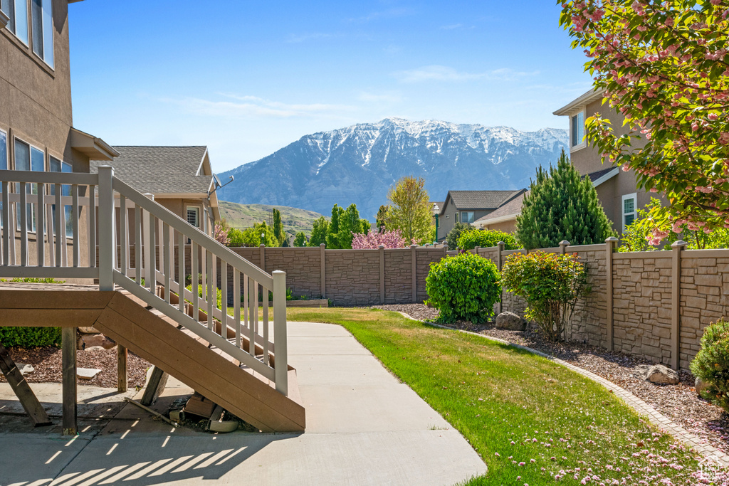 Fenced backyard featuring a mountain view