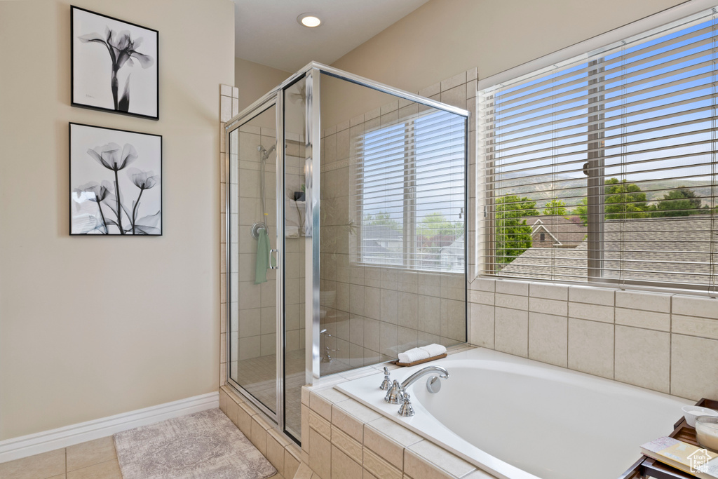 Bathroom featuring a bath, a shower stall, tile patterned flooring, and recessed lighting