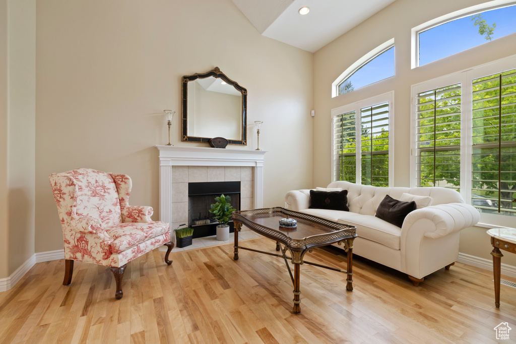 Living room with healthy amount of natural light, wood finished floors, a fireplace, and recessed lighting