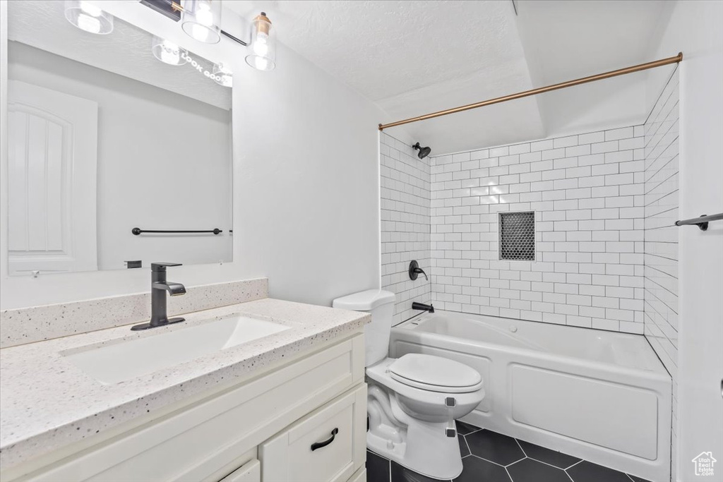 Bathroom with vanity, shower / bathtub combination, and tile patterned flooring