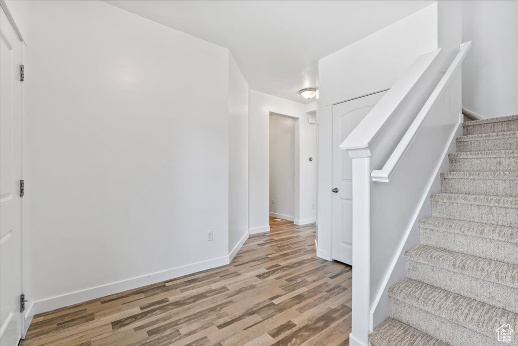 Stairs featuring wood finished floors and baseboards