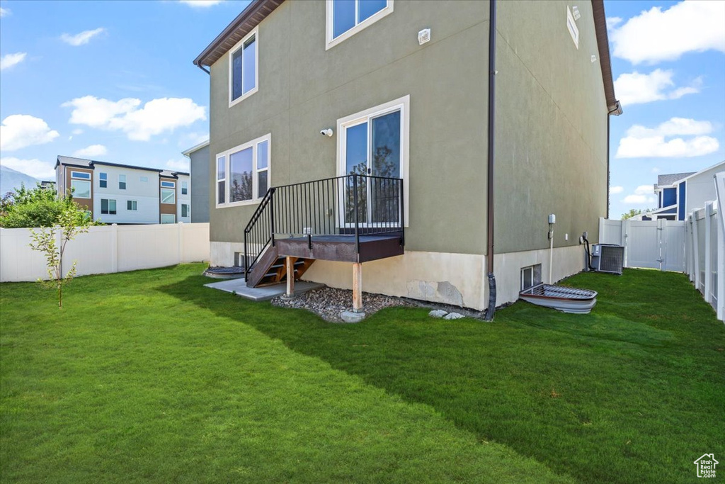 Back of house with a fenced backyard and stucco siding
