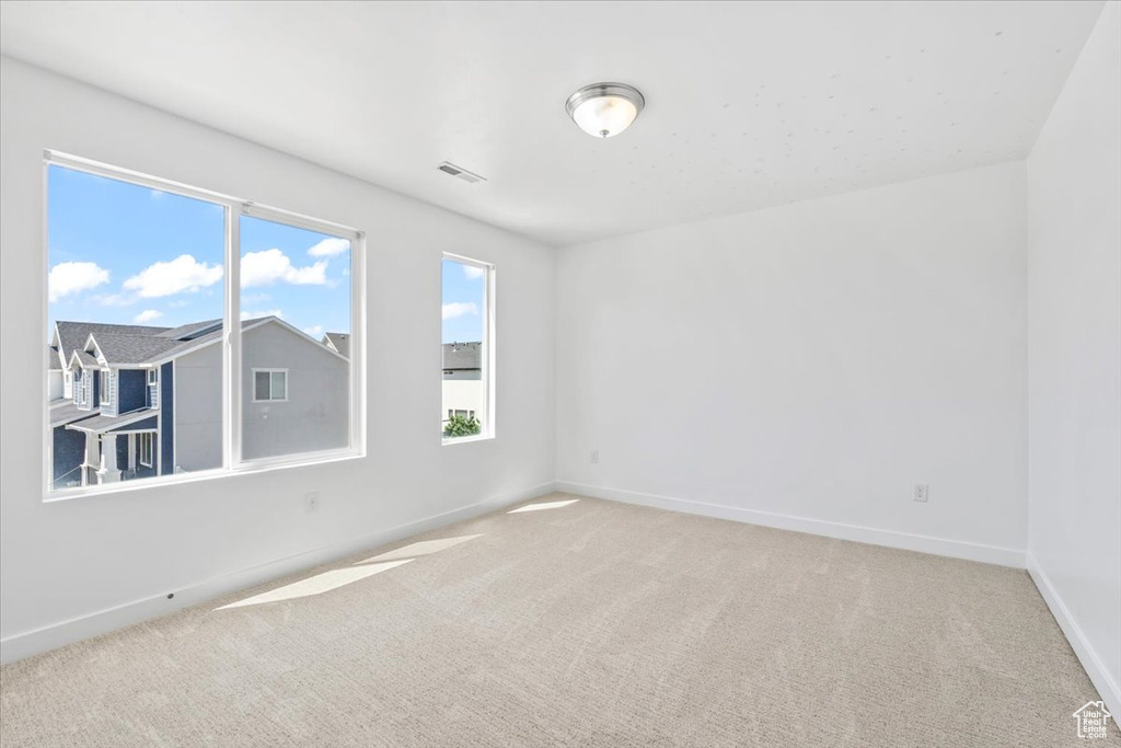 Empty room with carpet floors and baseboards