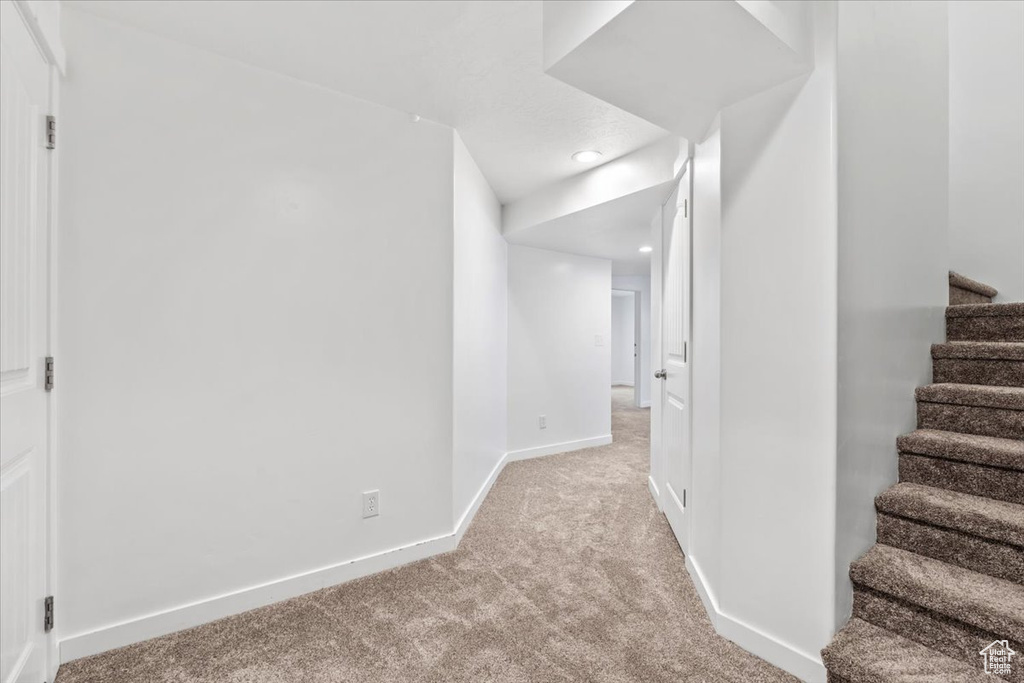 Hallway with carpet flooring, stairway, and recessed lighting
