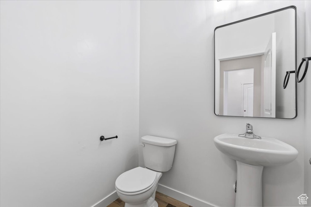 Bathroom with baseboards and wood finished floors