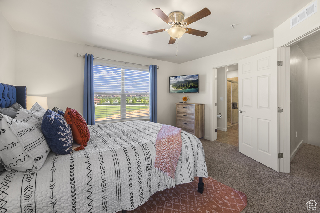 Carpeted bedroom featuring ceiling fan
