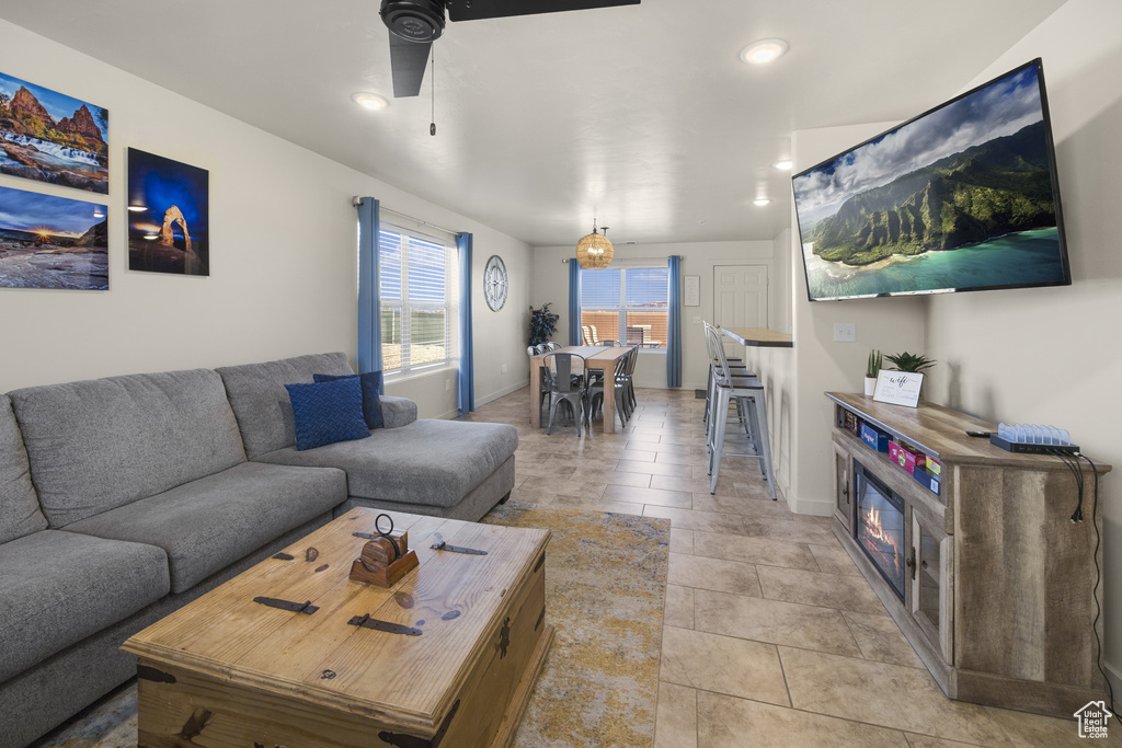Living room featuring ceiling fan, recessed lighting, and light tile patterned floors